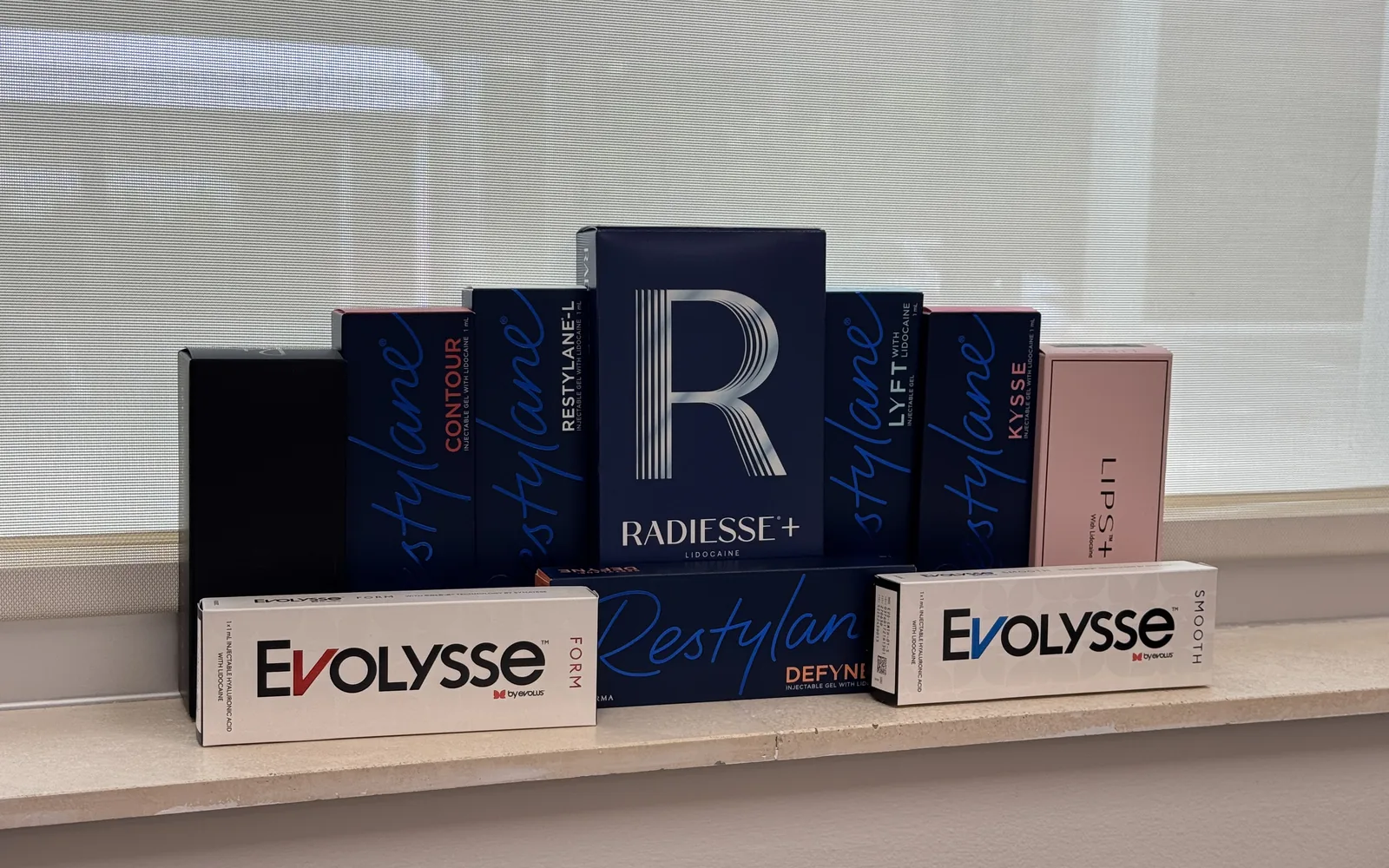 Boxes of Radiesse, Restylane Defyne, Contour, Lyft and Kysse, and Evolysse at The Ginger Injector